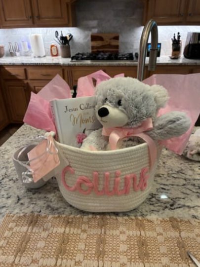 Customer photo: a basket with the name Collins filled with gifts