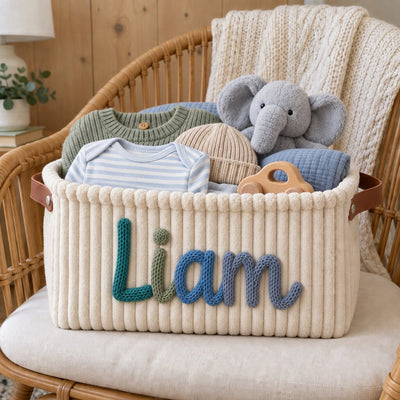 Close-up of the name Liam formed by hand in cotton yarn